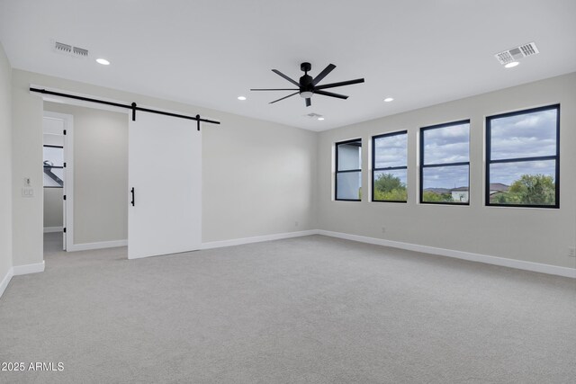 26655 S 169th Pl, Queen Creek, AZ 85142 - spare room with light carpet, a ceiling fan, visible vents, and a barn door