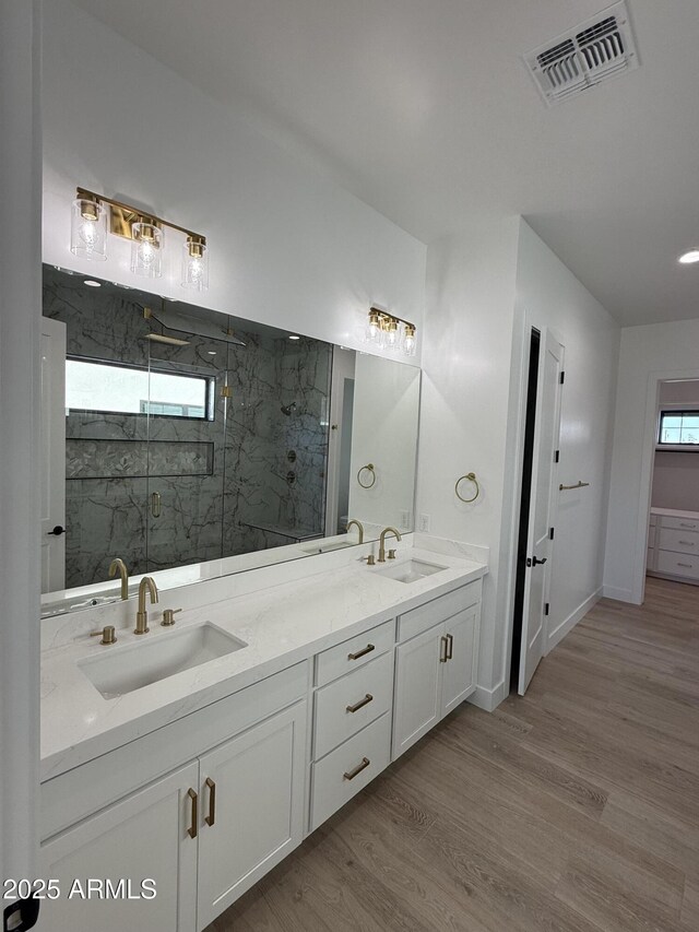 26655 S 169th Pl, Queen Creek, AZ 85142 - full bath featuring a sink, visible vents, a marble finish shower, and wood finished floors