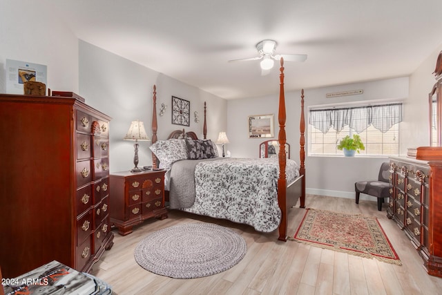 bedroom featuring baseboards, ceiling fan, and wood finished floors