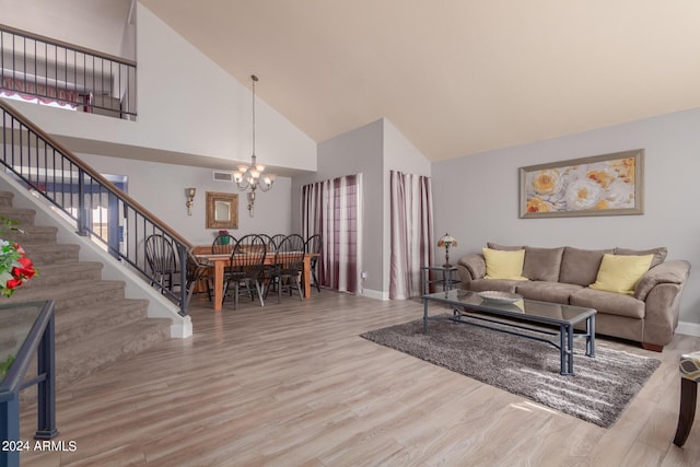 living area featuring a chandelier, visible vents, stairs, and wood finished floors