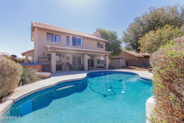 view of pool featuring a patio, fence, a fenced in pool, and a grill