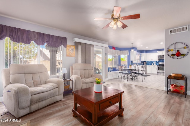 living area featuring recessed lighting, visible vents, ceiling fan, and light wood finished floors