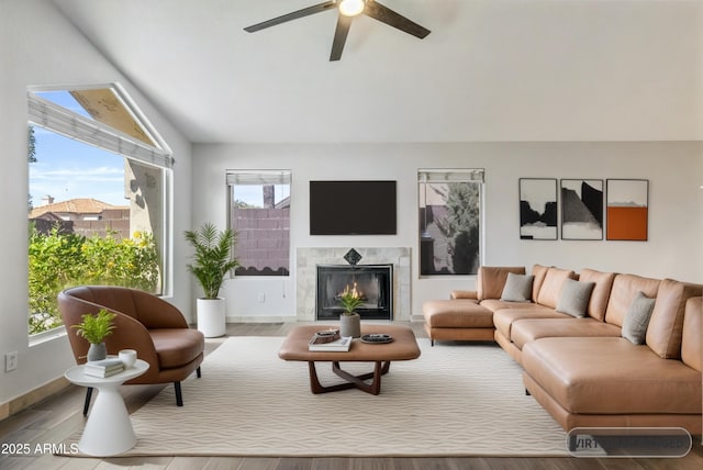 1962 E Morrow Dr, Phoenix, AZ 85024 - living room with lofted ceiling, a ceiling fan, a high end fireplace, wood finished floors, and baseboards
