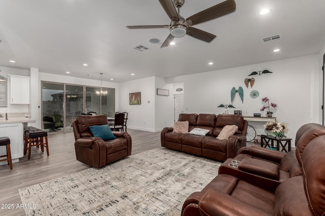 935 Calle Azul, Wickenburg, AZ 85390 - living area featuring light wood-style flooring, ceiling fan with notable chandelier, visible vents, and recessed lighting