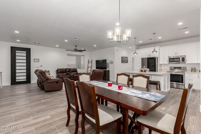 935 Calle Azul, Wickenburg, AZ 85390 - dining room with recessed lighting, visible vents, light wood-type flooring, baseboards, and ceiling fan with notable chandelier