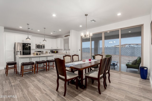 935 Calle Azul, Wickenburg, AZ 85390 - dining area featuring wood tiled floor, visible vents, a chandelier, and recessed lighting