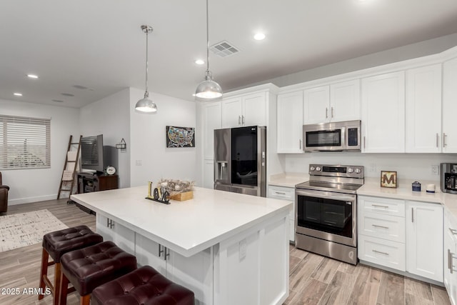 935 Calle Azul, Wickenburg, AZ 85390 - kitchen featuring appliances with stainless steel finishes, white cabinets, light countertops, and visible vents