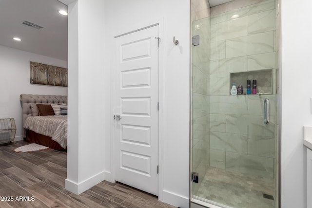 935 Calle Azul, Wickenburg, AZ 85390 - ensuite bathroom with a stall shower, wood tiled floor, visible vents, and baseboards