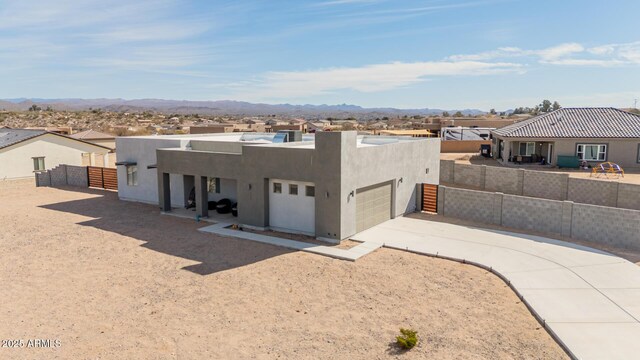 935 Calle Azul, Wickenburg, AZ 85390 - southwest-style home featuring a mountain view, a garage, fence, driveway, and stucco siding