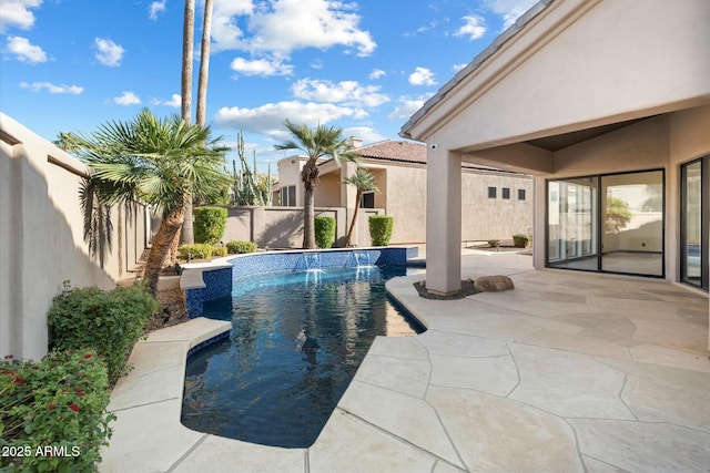 view of swimming pool with pool water feature and a patio