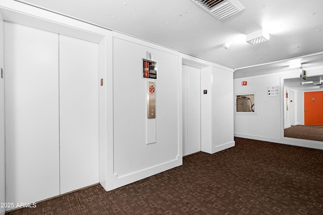 hallway with visible vents and carpet floors