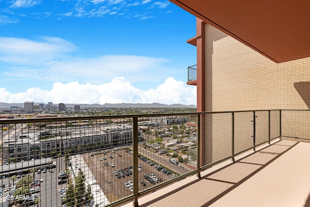 balcony with a mountain view and a view of city