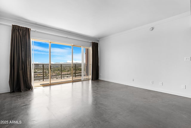 unfurnished room with ornamental molding, baseboards, and finished concrete flooring