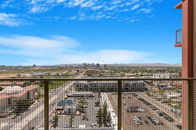 balcony with a mountain view and a city view