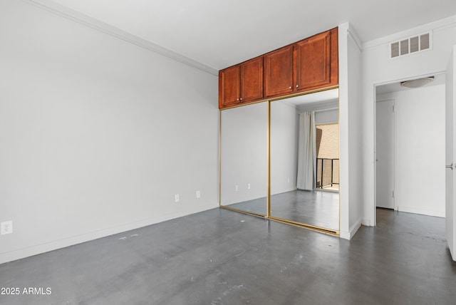 unfurnished bedroom with visible vents, baseboards, a closet, ornamental molding, and finished concrete floors