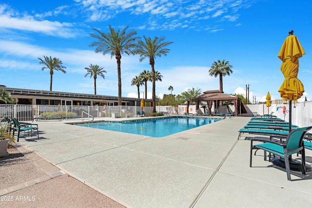 community pool featuring a patio area, a gazebo, and fence
