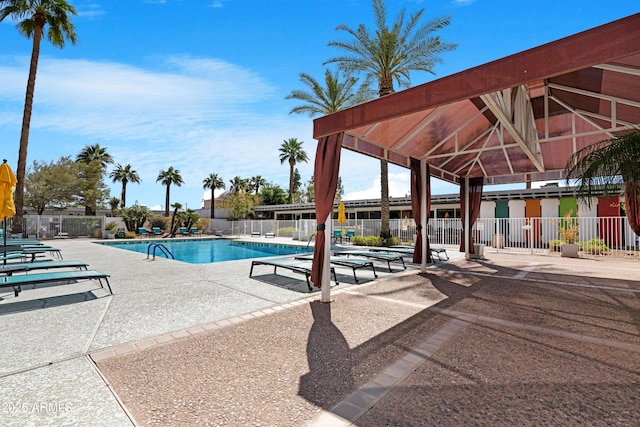 pool with fence and a patio
