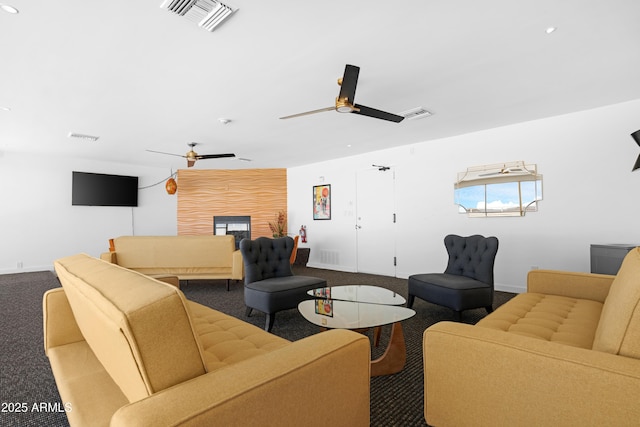 living room featuring dark colored carpet and visible vents