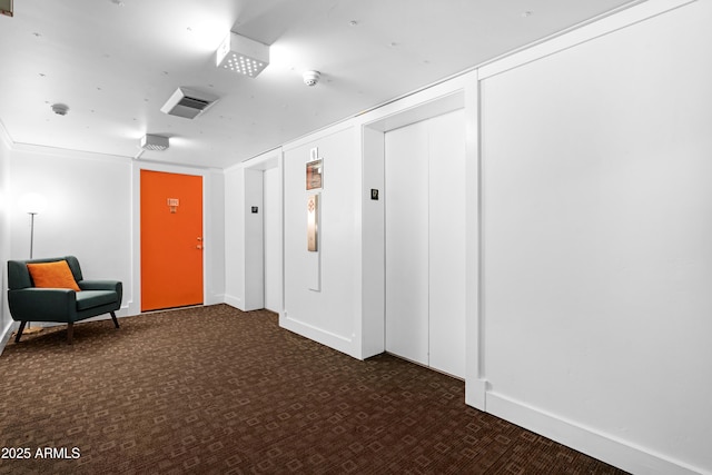 living area featuring dark carpet, baseboards, and visible vents