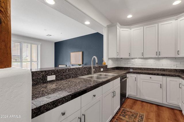 kitchen with backsplash, sink, light wood-type flooring, and white cabinetry