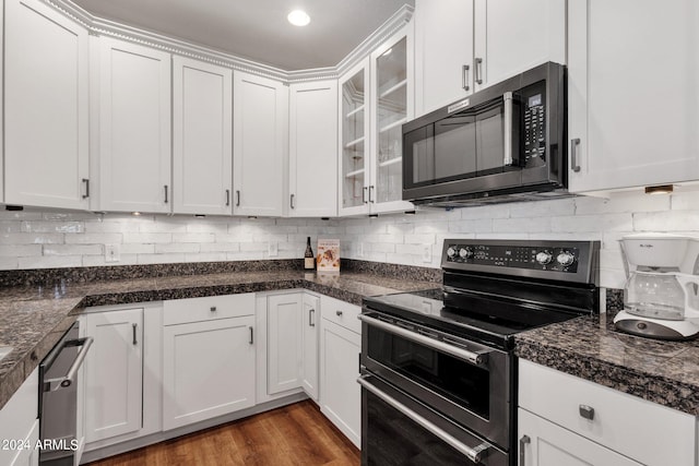 kitchen with appliances with stainless steel finishes, dark hardwood / wood-style flooring, backsplash, and white cabinetry