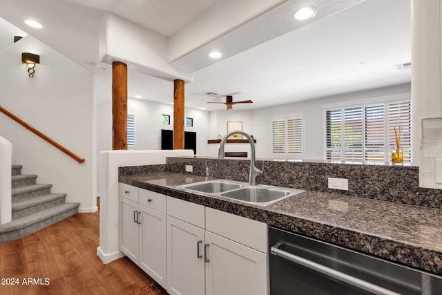 kitchen with white cabinets, sink, stainless steel dishwasher, light hardwood / wood-style floors, and ceiling fan