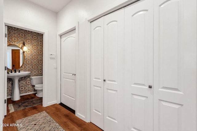 corridor with hardwood / wood-style flooring