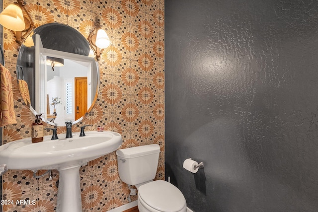 bathroom with tile walls and toilet