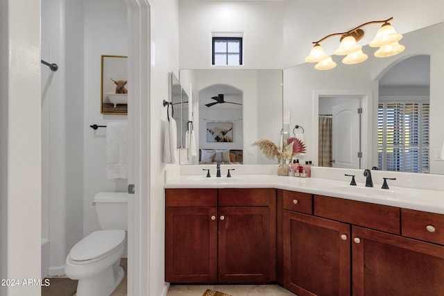 bathroom featuring tile flooring, a wealth of natural light, toilet, and dual vanity