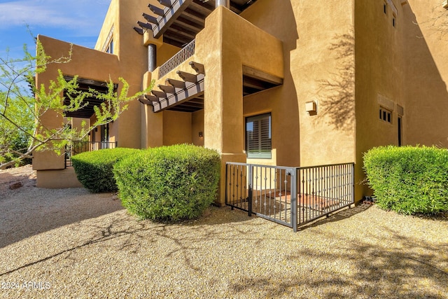 view of exterior entry featuring a balcony