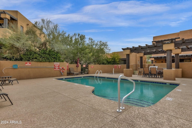 view of swimming pool featuring a patio and a bar