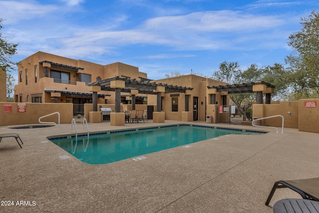 view of pool featuring area for grilling and a patio area