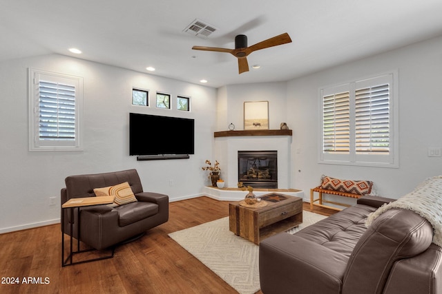 living room with wood-type flooring, ceiling fan, and a healthy amount of sunlight