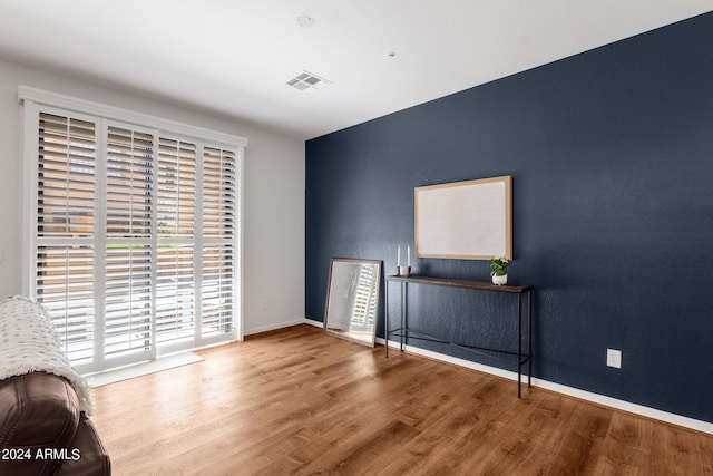 unfurnished room with hardwood / wood-style flooring