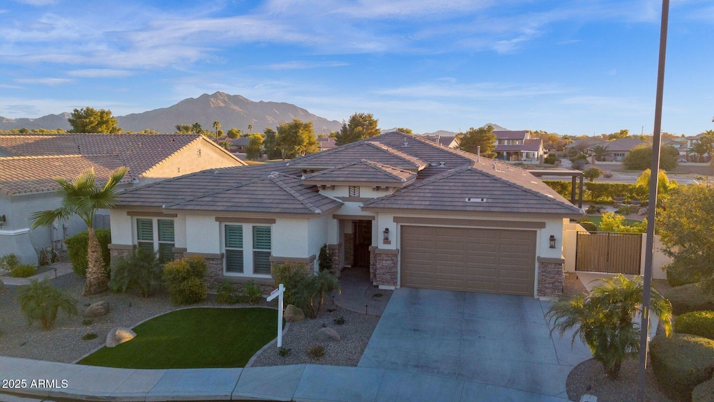 view of front of home with a garage and a mountain view