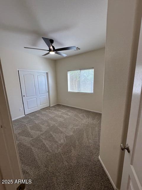 20985 N 81st Dr, Peoria, AZ 85382 - unfurnished bedroom featuring carpet floors, baseboards, a closet, and a ceiling fan