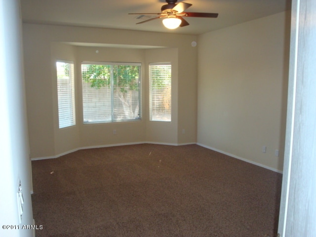 20985 N 81st Dr, Peoria, AZ 85382 - empty room with a ceiling fan, carpet floors, and baseboards