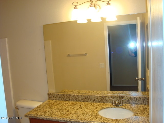 20985 N 81st Dr, Peoria, AZ 85382 - bathroom with a chandelier, vanity, and toilet
