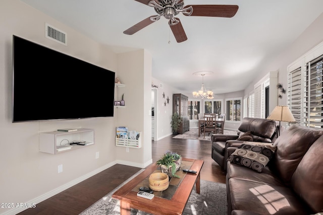 living room featuring dark hardwood / wood-style floors and ceiling fan with notable chandelier