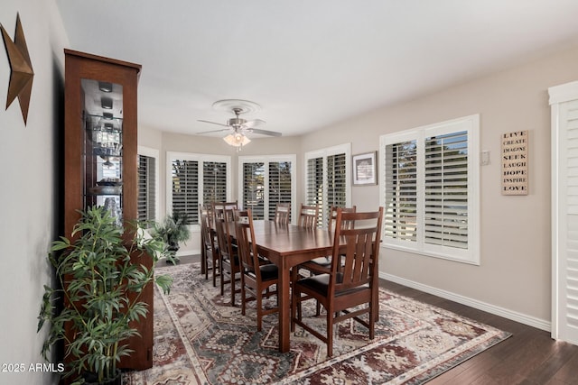 dining space featuring ceiling fan and dark hardwood / wood-style flooring