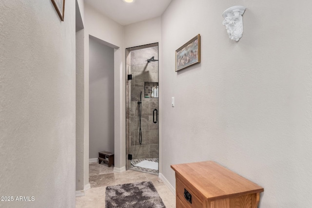 interior space featuring a shower with shower door