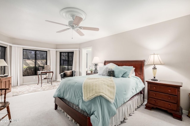 bedroom featuring light carpet and ceiling fan