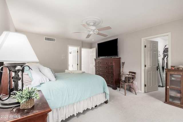 carpeted bedroom featuring a closet and ceiling fan