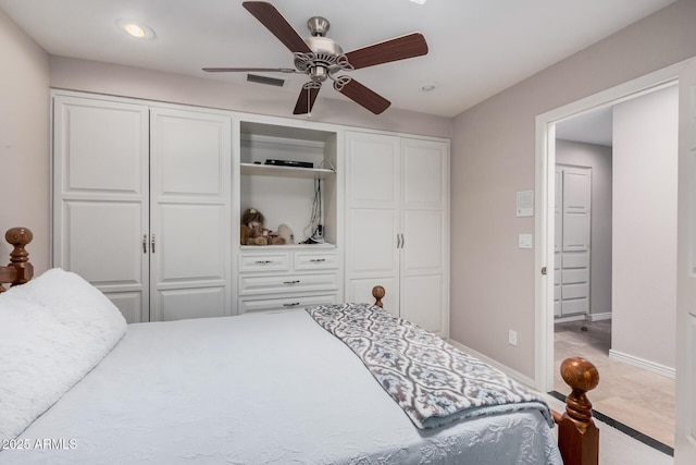 bedroom with multiple closets and ceiling fan