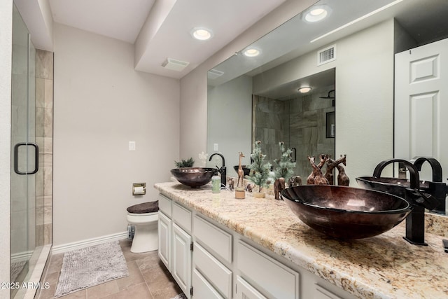 bathroom with vanity, toilet, and a shower with shower door