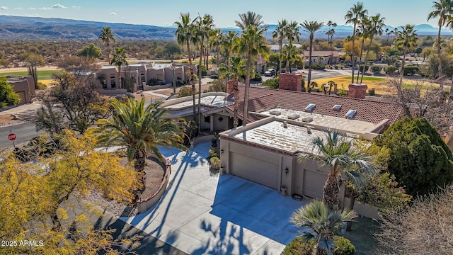 birds eye view of property with a mountain view