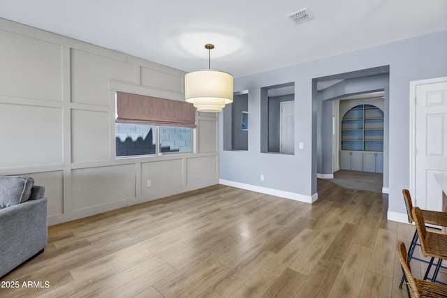 1272 W Joshua Tree Ave, Queen Creek, AZ 85140 - unfurnished dining area with light wood finished floors and baseboards