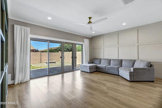 1272 W Joshua Tree Ave, Queen Creek, AZ 85140 - living room with a decorative wall, ceiling fan, light wood-style flooring, and recessed lighting