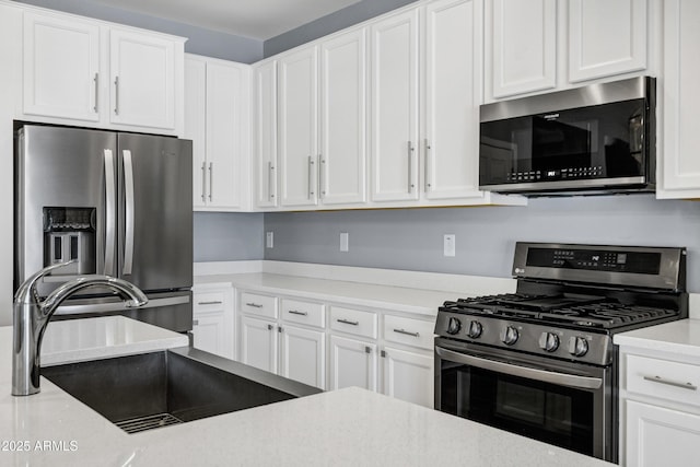 1272 W Joshua Tree Ave, Queen Creek, AZ 85140 - kitchen featuring appliances with stainless steel finishes, a sink, and white cabinets