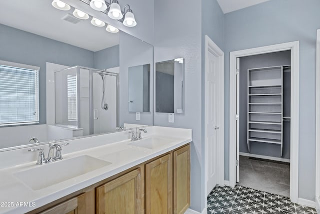 1272 W Joshua Tree Ave, Queen Creek, AZ 85140 - full bathroom with a shower stall, a walk in closet, baseboards, and double vanity